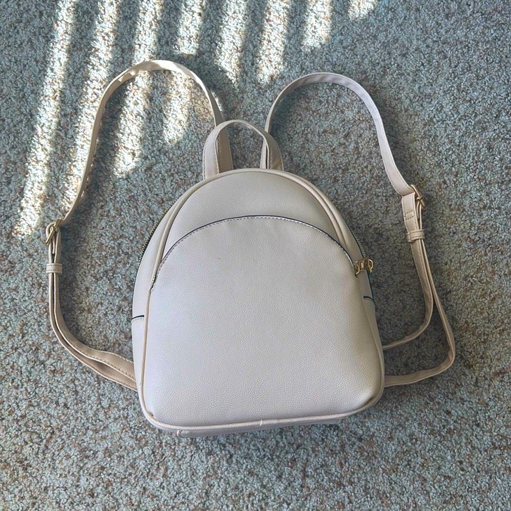 beige color mini backpack with gold zipper!